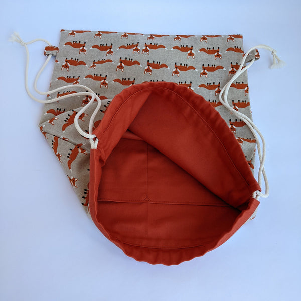 Open Fox Drawstring Bag with Burnt umber lining and ivory drawcords. Two internal pockets.