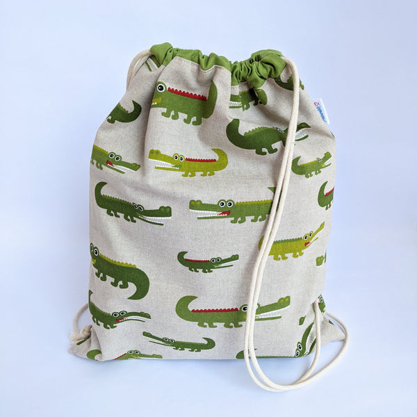 Crocodile drawstring bag with green lining and natural drawcords