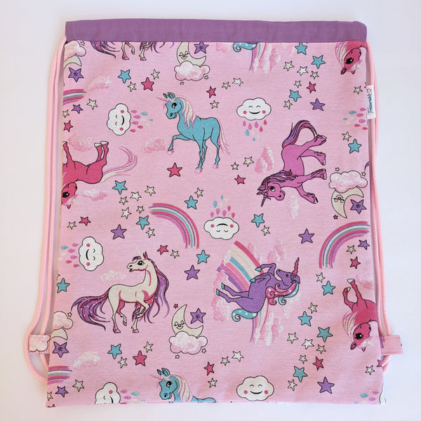 Unicorn drawstring bag with purple lining and baby pink drawcords