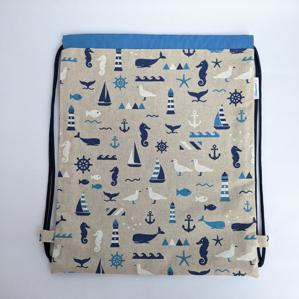 Nautical drawstring backpack with medium blue lining and navy drawcords