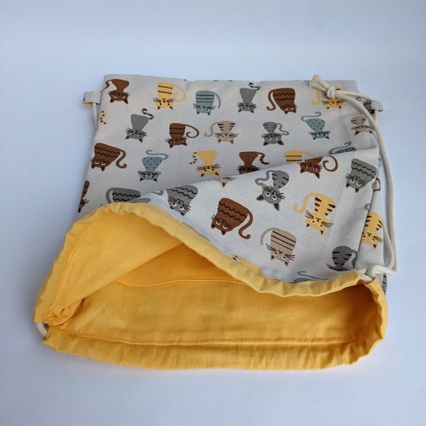 Open Classic Cats Drawstring backpack with corn yellow lining and natural drawcords. Two internal pockets