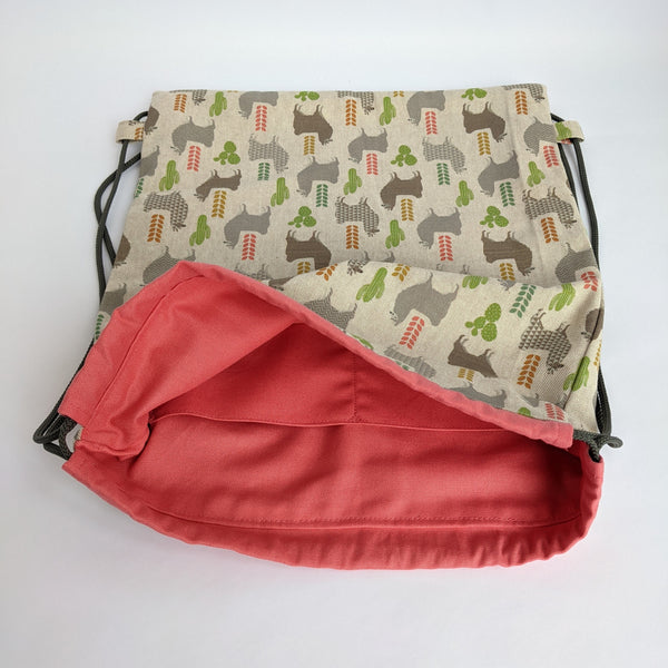 Open Llamas Drawstring backpack with coral pink lining and dark grey drawcords. Two internal pockets