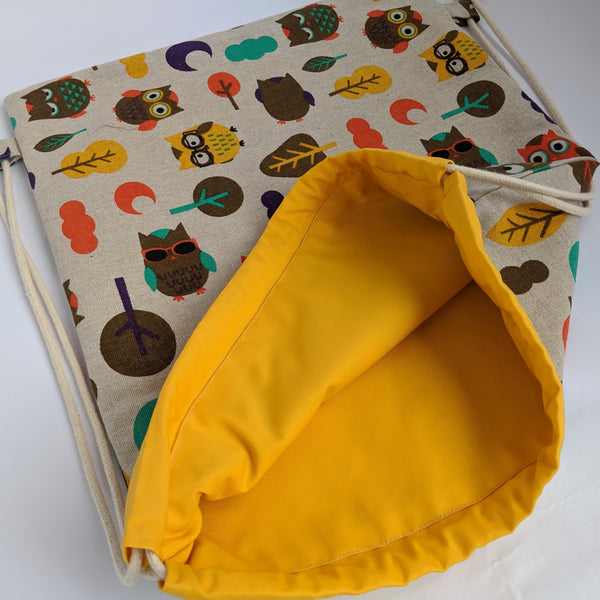 Open Owl drawstring bag showing bright yellow lining