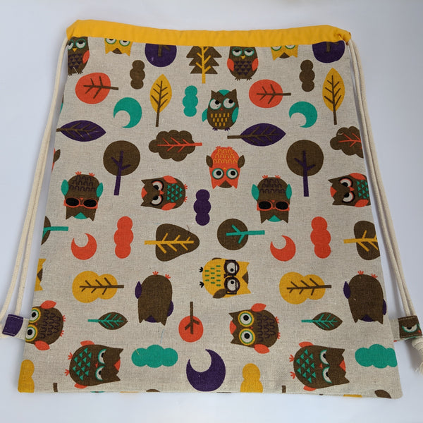 Owl Drawstring bag with yellow lining.