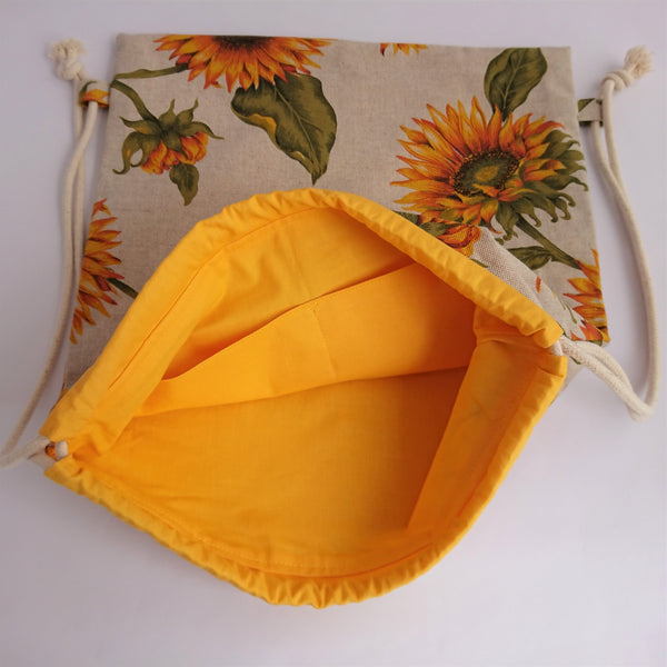 Open sunflower drawstring bag showing yellow lining with internal pockets