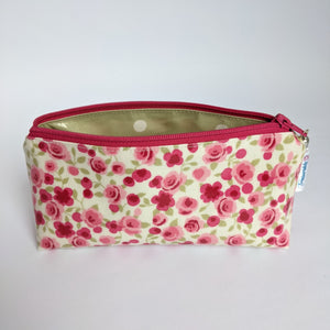 Unzipped, Mini Oilcloth pouch in pink floral design and sage spotty lining