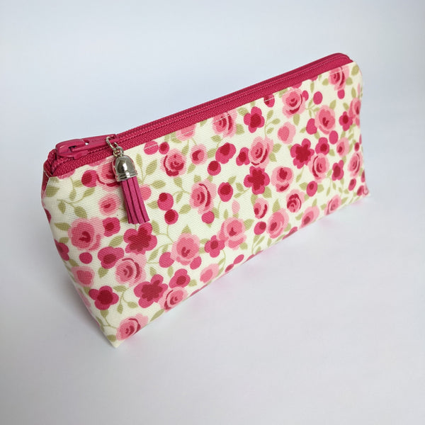 Side view of mini oilcloth pouch in pink floral design