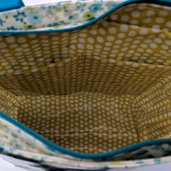 Close up view of the inside of Large Teal Floral Oilcloth Shoulder Bag with Teal Cotton Webbing Handles and Recessed Zip